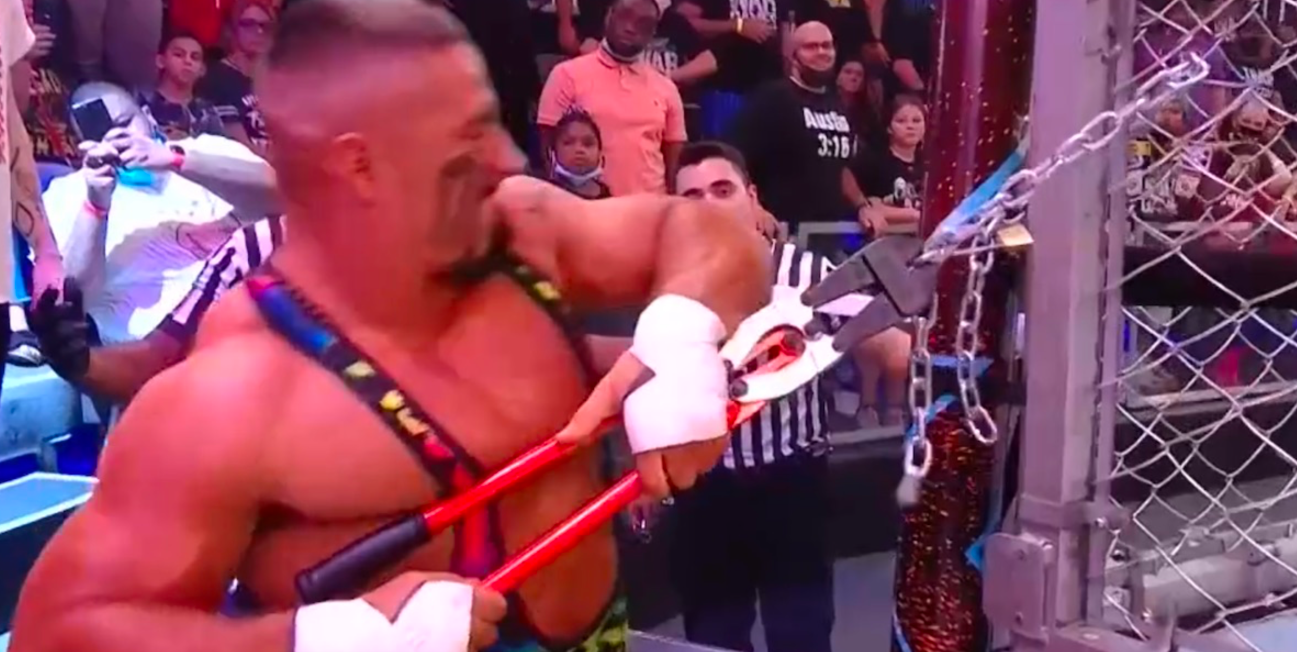 Bron Breakker tries and fails to cut through the chains of the WarGames cage with a pair of bolt cutters