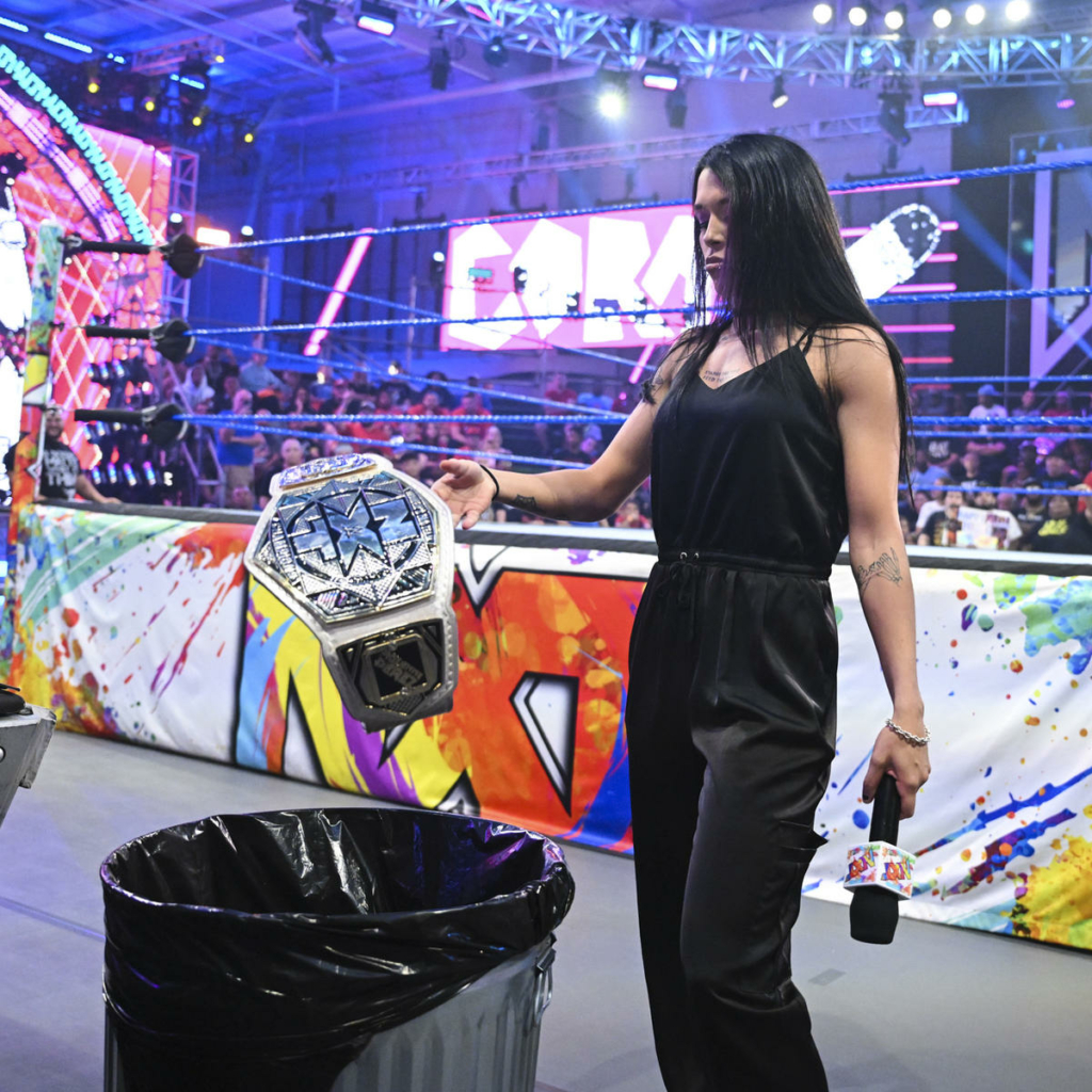 Cora Jade contemplates throwing a title belt in the trash.