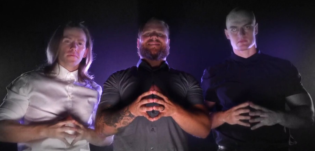 Joe Gacy and his friends in Schism menacingly tent their fingers.
