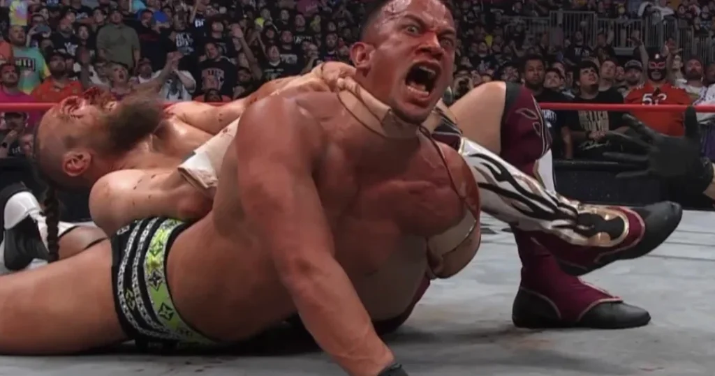 Bryan Danielson chokes a bloodied Ricky Starks out with a leather strap