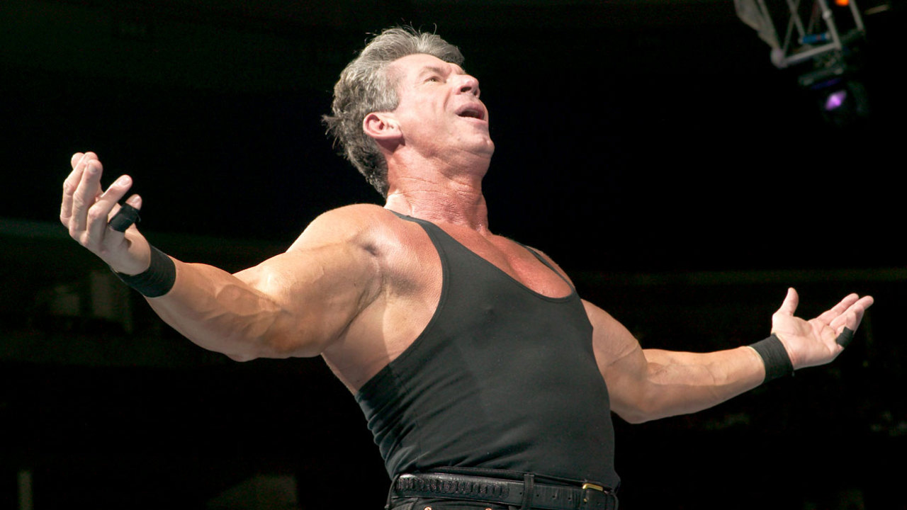 Vince McMahon taunts the crowd, or God, or both.