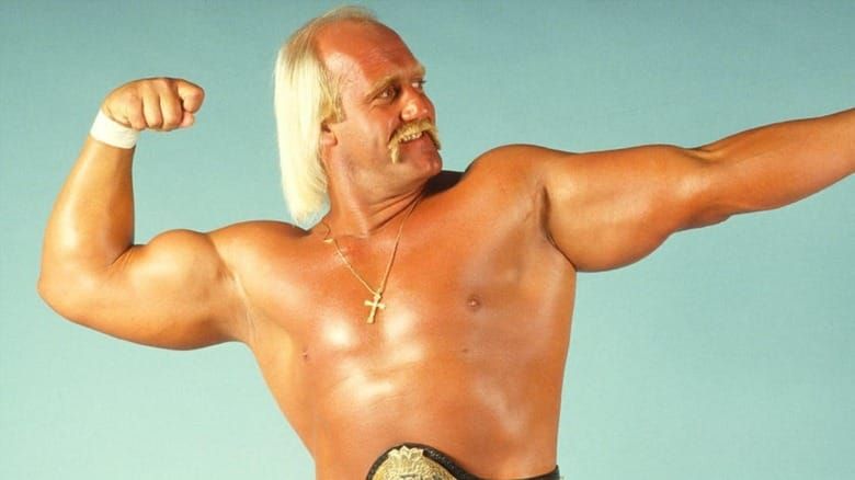 Hulk Hogan flexes his muscles, skullet flowing from the back and sides of his head.