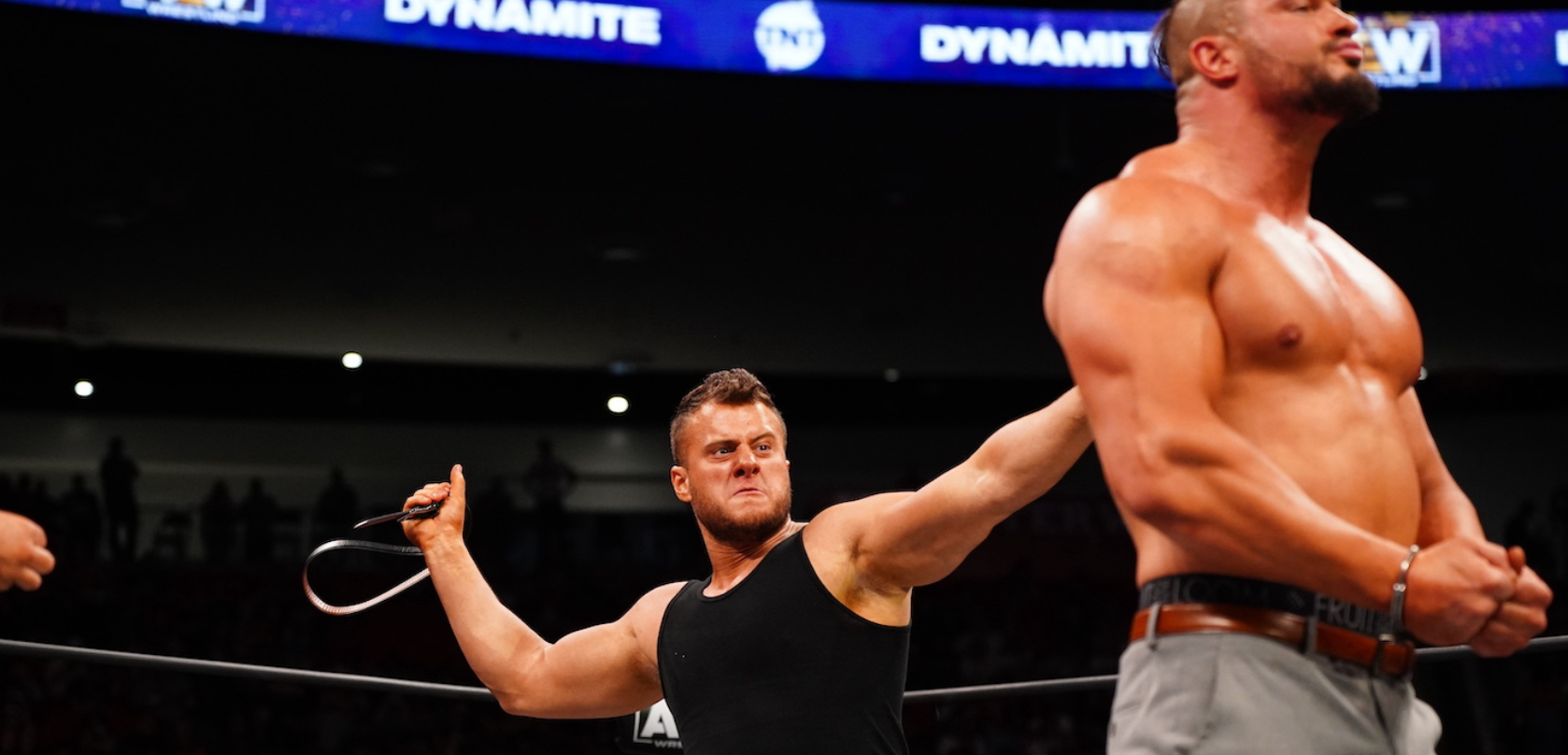 MJF whips a stoic, handcuffed Wardlow with a leather belt.