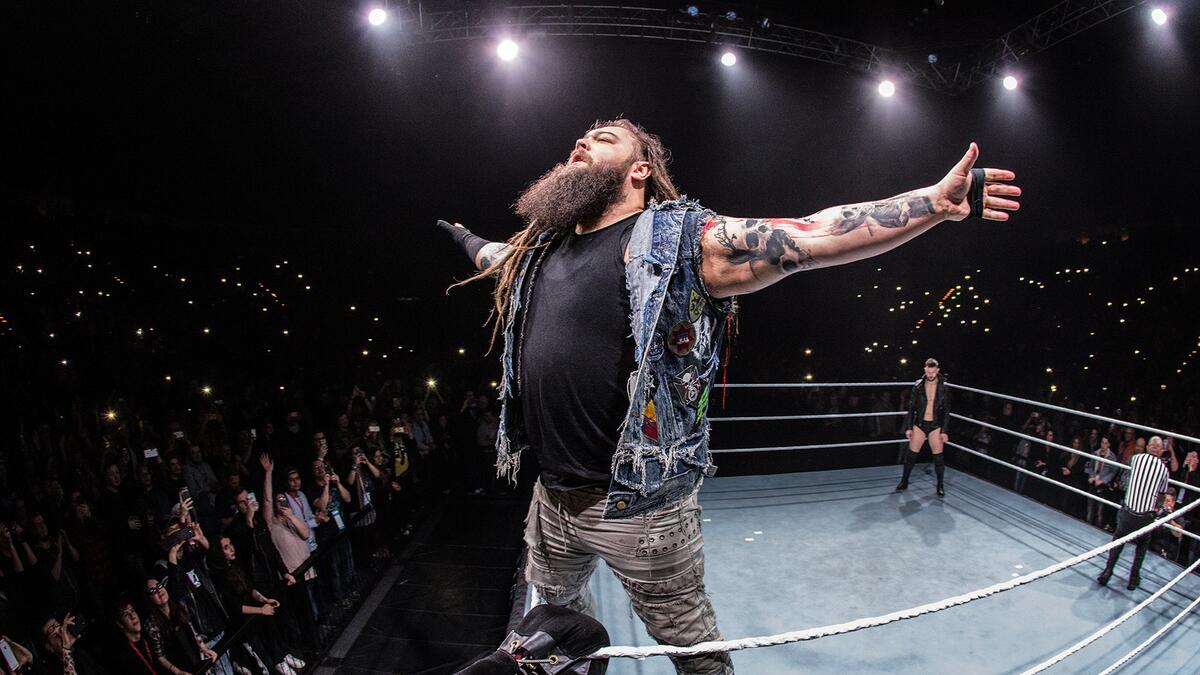 Bray Wyatt stands on the turnbuckle with his arms outstretched to the crowd before a match against Finn Balor